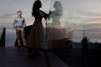 Artistic double exposure sunset portrait of Ummae and Ryan during their Indian destination wedding celebration overlooking the ocean

