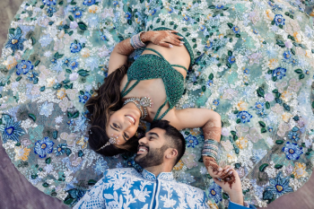 Close-up of Indian bride in embellished green lehenga with intricate beadwork and jewelry during sangeet night