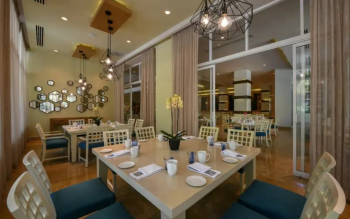 Elegant interior of Cocotal restaurant at El Dorado Royale featuring modern décor, soft lighting, and an inviting dining atmosphere for breakfast and dinner service. Elegant interior of Cocotal restaurant at El Dorado Royale featuring modern décor, soft lighting, and an inviting dining atmosphere for breakfast and dinner service.
