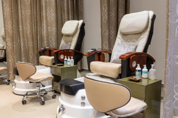 Interior of a resort beauty salon with pedicure chairs, manicure stations, and a relaxing spa-style setup