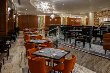 Interior of El Manglar restaurant with modern seating, buffet layout, and warm lighting for a casual dining experience