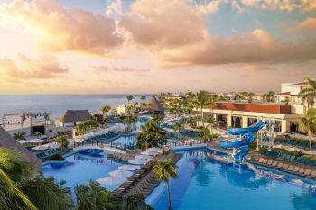 Aerial view of the Nizuc section showing resort pools, water slides, palm trees, and oceanfront setting