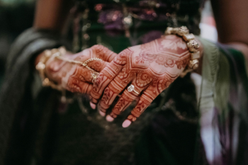 Close-up of Katherine's intricate bridal
mehndi featuring detailed henna patterns and her engagement ring.