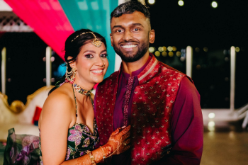 Katherine and Marun pose together during
their sangeet celebration in colorful traditional attire.