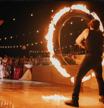 A fire performer entertains wedding guests
with a dramatic fire display during the evening celebration. A fire performer entertains wedding guests
with a dramatic fire display during the evening celebration.