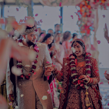 Meha and Gilbert walk hand in hand
following their Hindu wedding ceremony as flower petals fall around them. Meha and Gilbert walk hand in hand
following their Hindu wedding ceremony as flower petals fall around them.