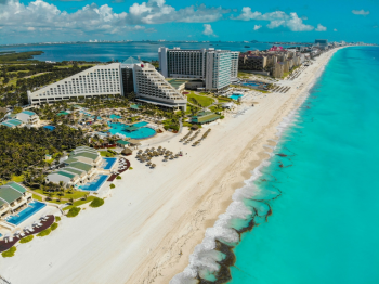 Aerial view of Cancun Mexico beachfront resorts with turquoise water and white sand beaches