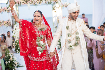 Priyanka and Varun celebrating during their Indian wedding ceremony at Planet Hollywood Cancun with guests
