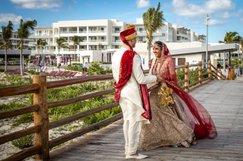 Raveena and Shyamal during a first look moment at Planet Hollywood Cancun with resort and beachfront surroundings