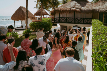 Wedding guests walking between event venues during a multi-day Indian destination wedding at a beachfront resort. Wedding guests walking between event venues during a multi-day Indian destination wedding at a beachfront resort.