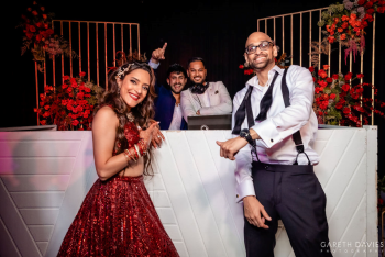 Digisha and Ronak celebrate with MC Jay Patel and DJ Sunny P during their South Asian destination wedding at Dreams Bahia Mita, highlighting the importance of outside vendor flexibility at wedding resorts in Mexico. Digisha and Ronak celebrate with MC Jay Patel and DJ Sunny P during their South Asian destination wedding at Dreams Bahia Mita, highlighting the importance of outside vendor flexibility at wedding resorts in Mexico.
