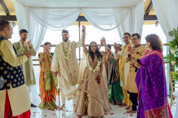 Pooja and Pratik celebrate under a mandap at their Indian destination wedding ceremony. Pooja and Pratik celebrate under a mandap at their Indian destination wedding ceremony.