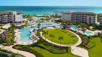 Aerial view of Dreams Playa Mujeres with beachfront pools, golf course surroundings, and oceanfront resort layout Aerial view of Dreams Playa Mujeres with beachfront pools, golf course surroundings, and oceanfront resort layout