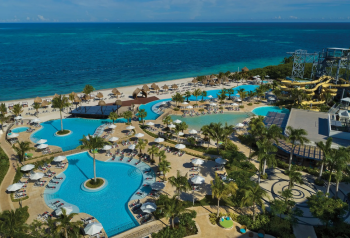 Beachfront view of Dreams Natura Resort & Spa with pools, palm trees, and natural mangrove surroundings Beachfront view of Dreams Natura Resort & Spa with pools, palm trees, and natural mangrove surroundings