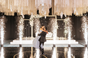 Indian bride and groom first dance surrounded by cold sparklers and crystal chandelier at Indian wedding reception at Grand Palladium Costa Mujeres, Playa Mujeres, Mexico