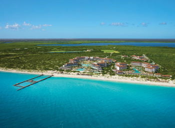 Aerial view of Dreams Playa Mujeres showcasing the modern all-inclusive resort, expansive Caribbean beach, and natural coastline that make Playa Mujeres a premier destination for Indian destination weddings in Mexico. Aerial view of Dreams Playa Mujeres showcasing the modern all-inclusive resort, expansive Caribbean beach, and natural coastline that make Playa Mujeres a premier destination for Indian destination weddings in Mexico.