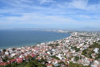 Aerial view of Puerto Vallarta, Mexico, showcasing Banderas Bay, the city's coastline, and the surrounding mountains that make it a unique destination for Indian destination weddings. Aerial view of Puerto Vallarta, Mexico, showcasing Banderas Bay, the city's coastline, and the surrounding mountains that make it a unique destination for Indian destination weddings.
