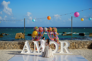 Janki and Nicolas pose during their colorful oceanfront sangeet at Generations Riviera Maya and El Dorado Royale during their Indian destination wedding in Mexico. Janki and Nicolas pose during their colorful oceanfront sangeet at Generations Riviera Maya and El Dorado Royale during their Indian destination wedding in Mexico.