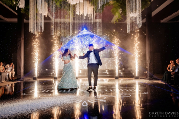 Kinjal and Kushal make their grand reception entrance at Planet Hollywood Cancun with cold sparklers, elegant décor, and a choreographed first dance during their Indian destination wedding in Mexico. Kinjal and Kushal make their grand reception entrance at Planet Hollywood Cancun with cold sparklers, elegant décor, and a choreographed first dance during their Indian destination wedding in Mexico.