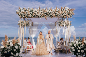 Nina and Avi during their Hindu wedding ceremony beneath a floral mandap overlooking the Caribbean Sea at Moon Palace The Grand in Cancun, Mexico. Nina and Avi during their Hindu wedding ceremony beneath a floral mandap overlooking the Caribbean Sea at Moon Palace The Grand in Cancun, Mexico.