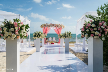 Elegant outdoor beach ceremony setup for Sanam and Savanth's Indian wedding at Royalton Splash Riviera Cancun in Cancun, Mexico featuring a beautiful floral mandap. Elegant outdoor beach ceremony setup for Sanam and Savanth's Indian wedding at Royalton Splash Riviera Cancun in Cancun, Mexico featuring a beautiful floral mandap.