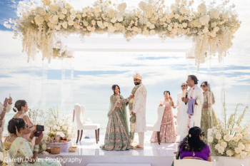 Palak and Jay exchange garlands beneath an elegant floral mandap during their Indian wedding ceremony at Hard Rock Hotel Cancun. Palak and Jay exchange garlands beneath an elegant floral mandap during their Indian wedding ceremony at Hard Rock Hotel Cancun.