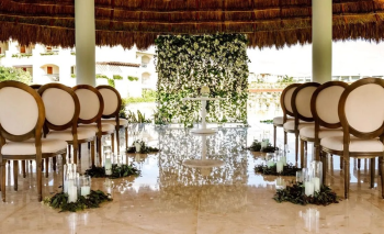 Round palapa gazebo wedding venue at Moon Palace The Grand decorated with a greenery and floral backdrop Round palapa gazebo wedding venue at Moon Palace The Grand decorated with a greenery and floral backdrop