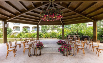 Wooden gazebo wedding venue at Moon Palace The Grand with a hanging floral installation and garden setting Wooden gazebo wedding venue at Moon Palace The Grand with a hanging floral installation and garden setting
