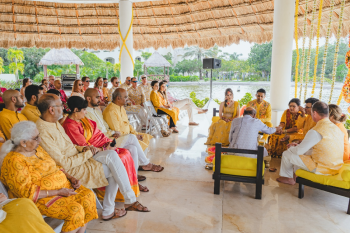 Wide view of a palapa gazebo set up for an Indian wedding Haldi ceremony with rows of white chairs Wide view of a palapa gazebo set up for an Indian wedding Haldi ceremony with rows of white chairs