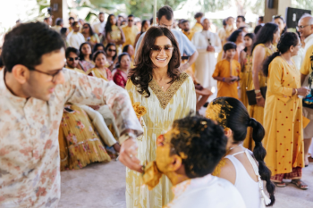 Guests applying Haldi paste to the faces of the couple at an Indian wedding Haldi ceremony Guests applying Haldi paste to the faces of the couple at an Indian wedding Haldi ceremony