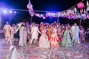 Wide view of guests dancing on a custom printed dance floor at an Indian wedding Sangeet Wide view of guests dancing on a custom printed dance floor at an Indian wedding Sangeet