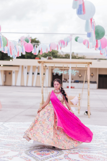 Bride dancing in a circle of guests at an Indian wedding Sangeet celebration Bride dancing in a circle of guests at an Indian wedding Sangeet celebration