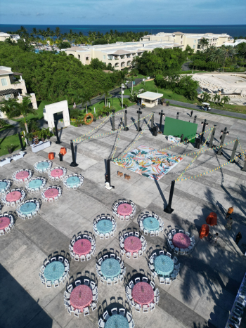 Aerial view of an outdoor plaza set up for an Indian wedding Sangeet with a custom dance floor