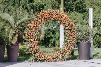 Floral moon arch entrance with illuminated couple's sign at an Indian wedding Sangeet Floral moon arch entrance with illuminated couple's sign at an Indian wedding Sangeet