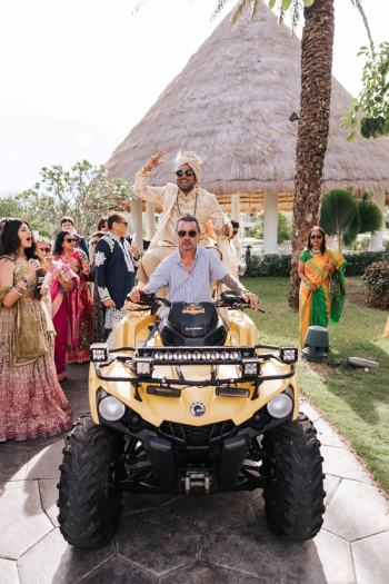 Groom arriving on an ATV for an Indian wedding baraat at a Cancun resort Groom arriving on an ATV for an Indian wedding baraat at a Cancun resort