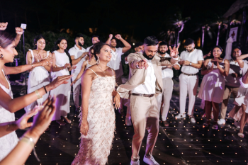 Bride and groom dancing at a post-wedding beach party celebration Bride and groom dancing at a post-wedding beach party celebration