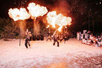 Fire dancers performing at a Mediterranean-inspired post-ceremony beach celebration Fire dancers performing at a Mediterranean-inspired post-ceremony beach celebration