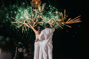 Fireworks display over a beach wedding celebration at night Fireworks display over a beach wedding celebration at night