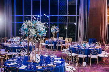 Reception table setting with blue linens and white hydrangea centerpieces Reception table setting with blue linens and white hydrangea centerpieces