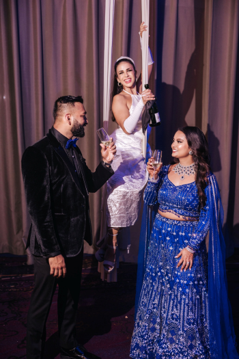 Aerial champagne performer at an Indian wedding reception ballroom Aerial champagne performer at an Indian wedding reception ballroom