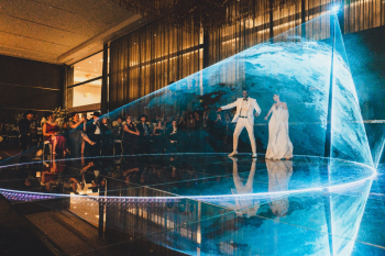 Bride and groom first dance inside a laser light halo at an Indian wedding reception Bride and groom first dance inside a laser light halo at an Indian wedding reception