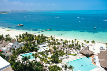 Aerial view of a Cancun Hotel Zone resort with white sand beaches and turquoise Caribbean water, a popular setting for Indian destination weddings Aerial view of a Cancun Hotel Zone resort with white sand beaches and turquoise Caribbean water, a popular setting for Indian destination weddings