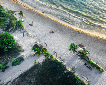 Aerial view of Riviera Maya's white sand beach and Caribbean coastline, a popular destination for Indian destination weddings in Mexico. Aerial view of Riviera Maya's white sand beach and Caribbean coastline, a popular destination for Indian destination weddings in Mexico.