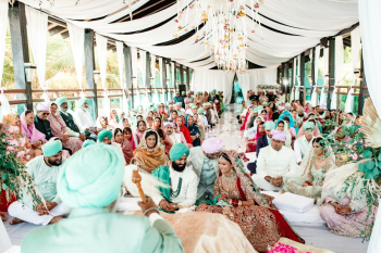 Guests in turquoise and lavender turbans seated on the floor during Komal and Jagraj's Anand Karaj ceremony at Generations Riviera Maya, part of their Mexico destination wedding Guests in turquoise and lavender turbans seated on the floor during Komal and Jagraj's Anand Karaj ceremony at Generations Riviera Maya, part of their Mexico destination wedding
