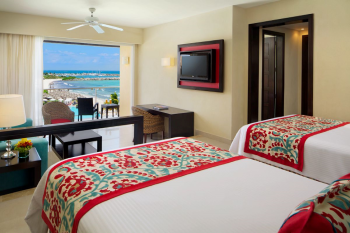 Junior suite at Dreams Jade Resort and Spa with two beds, a private balcony, and ocean views, part of the resort's accommodations for South Asian wedding guests. Junior suite at Dreams Jade Resort and Spa with two beds, a private balcony, and ocean views, part of the resort's accommodations for South Asian wedding guests.