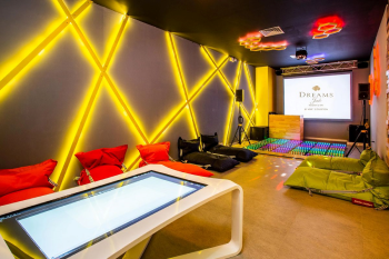 Core Zone Teens Club at Dreams Jade Resort and Spa featuring a lounge area with an interactive touch table, colorful lighting, and a dance floor for teenage guests. Core Zone Teens Club at Dreams Jade Resort and Spa featuring a lounge area with an interactive touch table, colorful lighting, and a dance floor for teenage guests.