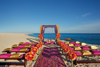Beach wedding ceremony setup with a colorful mandap at Dreams Los Cabos Suites Golf Resort & Spa Beach wedding ceremony setup with a colorful mandap at Dreams Los Cabos Suites Golf Resort & Spa