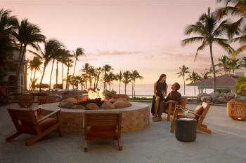 Couple relaxing by the fire pit at sunset at Dreams Los Cabos Suites Golf Resort & Spa AAAAAAAAAAAACouple relaxing by the fire pit at sunset at Dreams Los Cabos Suites Golf Resort & SpaAAAAAAAAAA