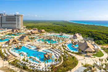 Aerial view of Moon Palace The Grand Punta Cana in the Dominican Republic, with its hotel tower, several pools, thatched-roof buildings and tropical gardens leading to the Caribbean coastline, featured in IDW's Indian wedding resort guide. Aerial view of Moon Palace The Grand Punta Cana in the Dominican Republic, with its hotel tower, several pools, thatched-roof buildings and tropical gardens leading to the Caribbean coastline, featured in IDW's Indian wedding resort guide.
